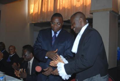 R - L: Chief Solo Akuma (SAN), being congratulated